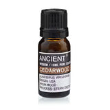 Bottle of Cedarwood essential oil with label on a white background