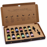Set of essential oil bottles in a cardboard box with labels on a white background